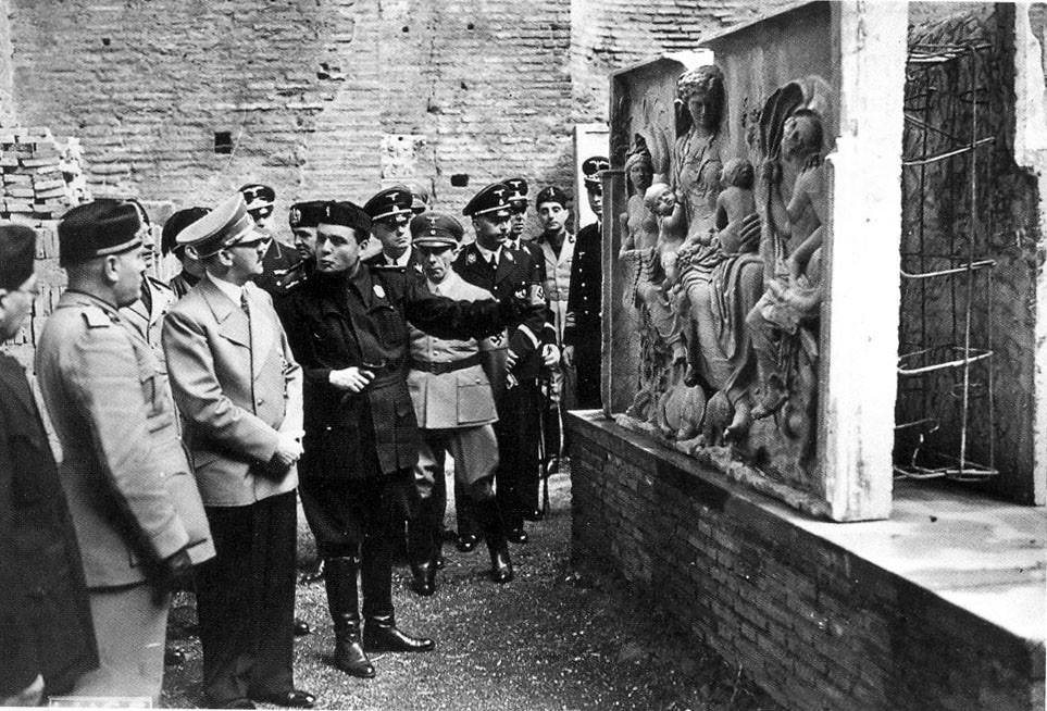 Archeologist Ranuccio Bianchi Bandinelli explaining a Roman bas-relief sculpture to Hitler